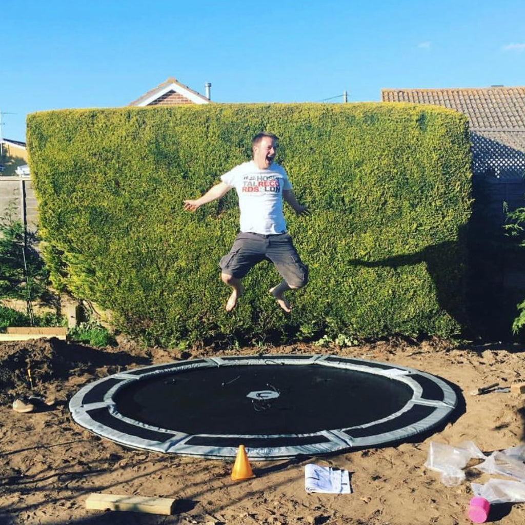 dad bouncing on trampoline